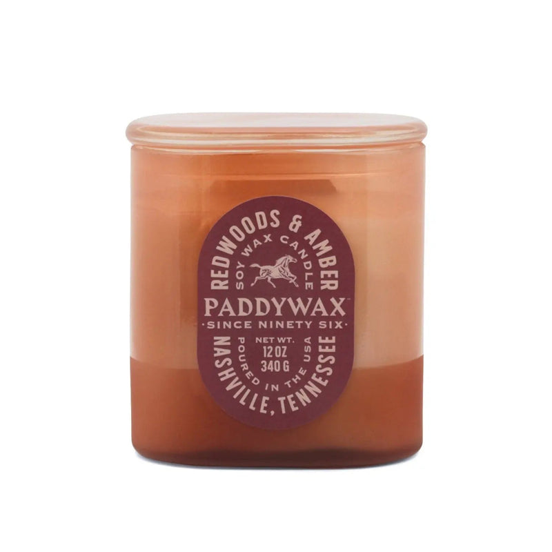 Redwoods and Amber Vista 12 oz candle in rusty pink glass