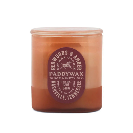 Redwoods and Amber Vista 12 oz candle in rusty pink glass